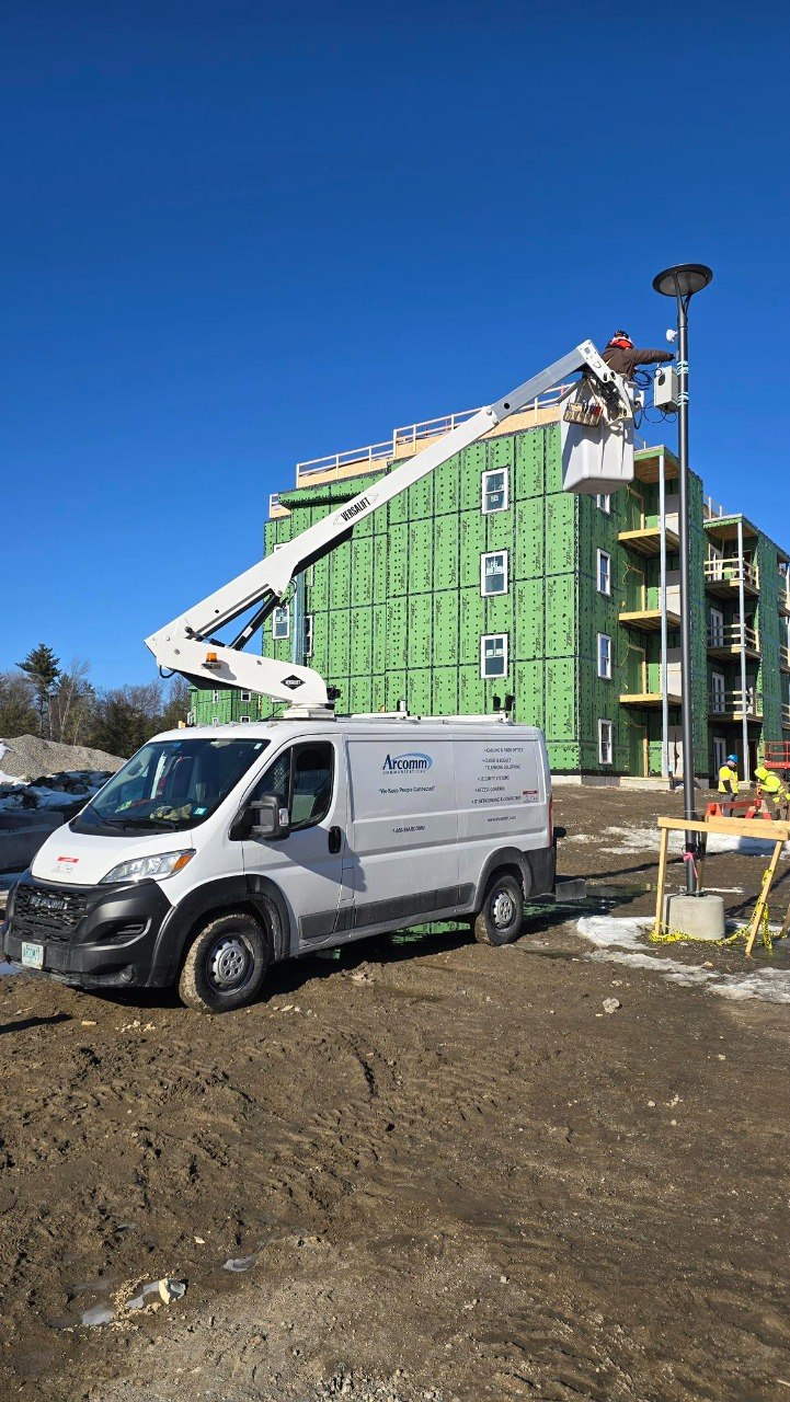 Arcomm technicians on site with bucket truck